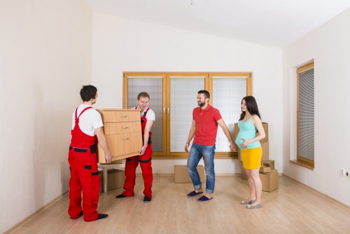 Moving team protecting furniture during a Southfields van service